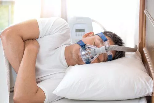 A man with an Oxygen mask for sleep