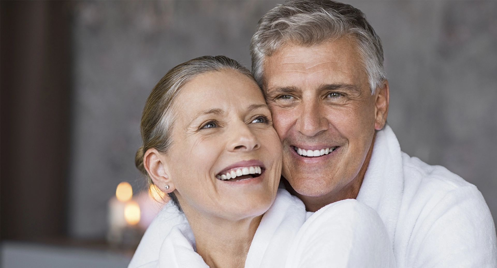 young old couple smiling in white dress