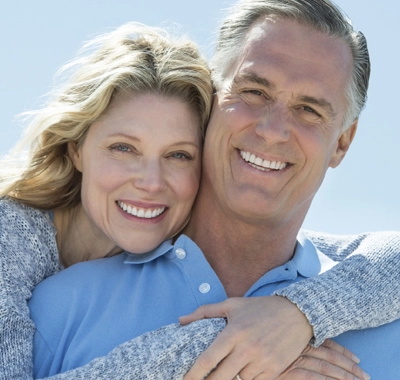 young old couple smiling with hug