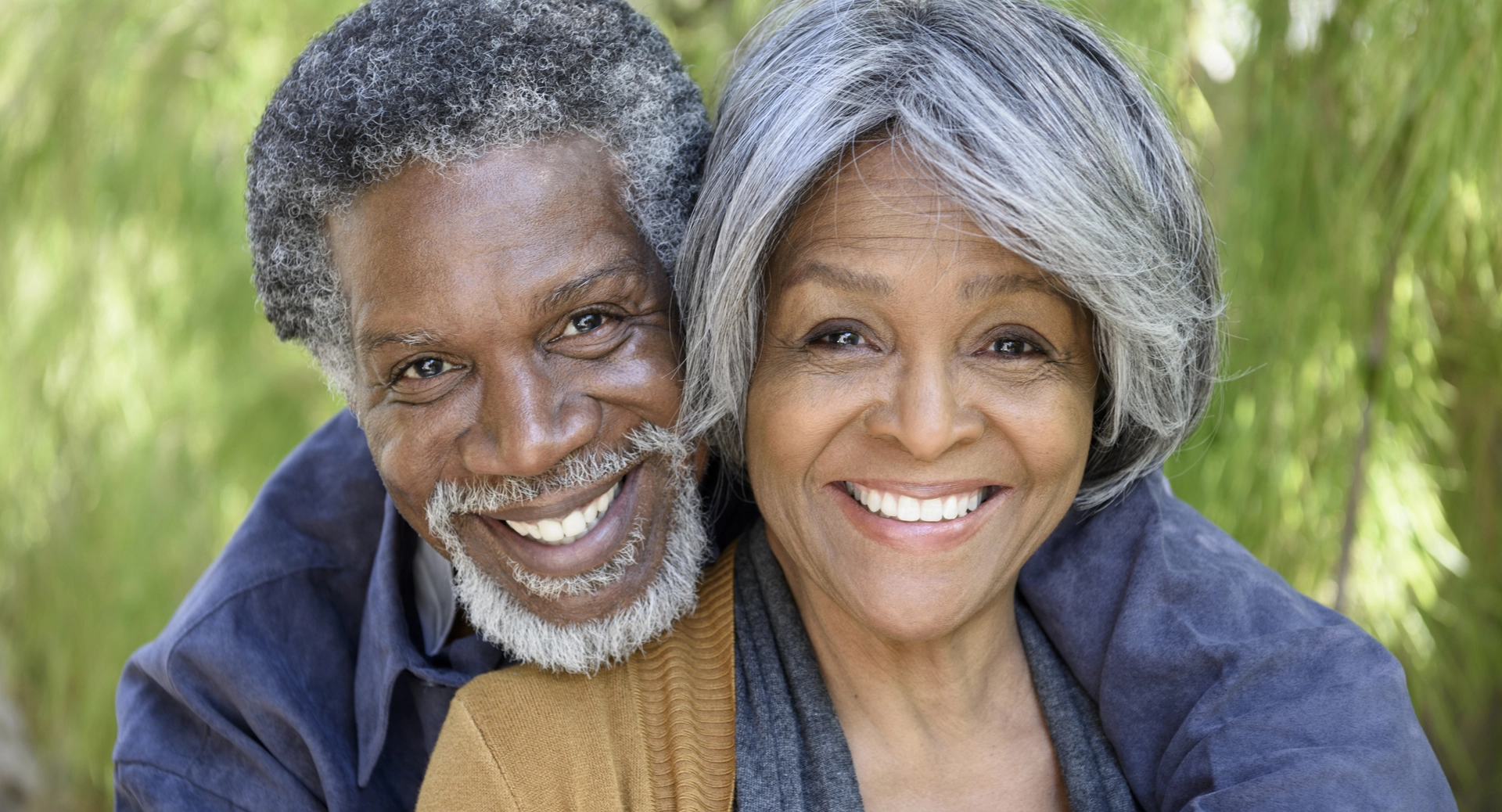 A young old couple smiling with hug